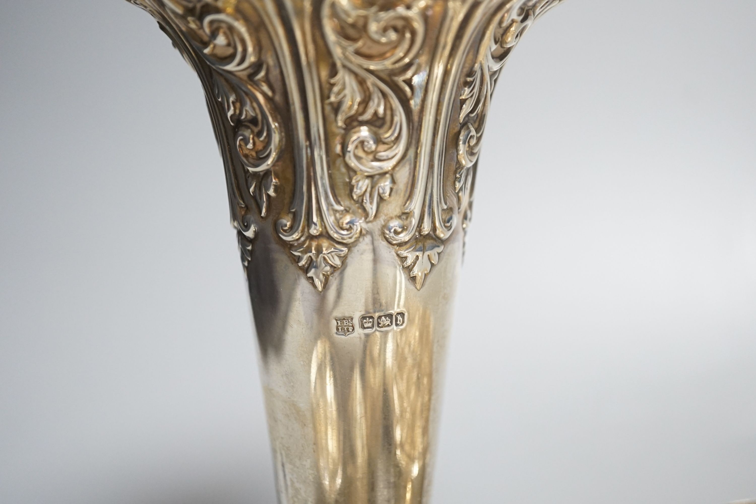 A late Victorian repousse silver vase, Sheffield, 1900, 17.9cm, loaded, a silver tea strainer and stand, a modern silver rose bowl, sterling dish, four condiments including two silver and six other items.
